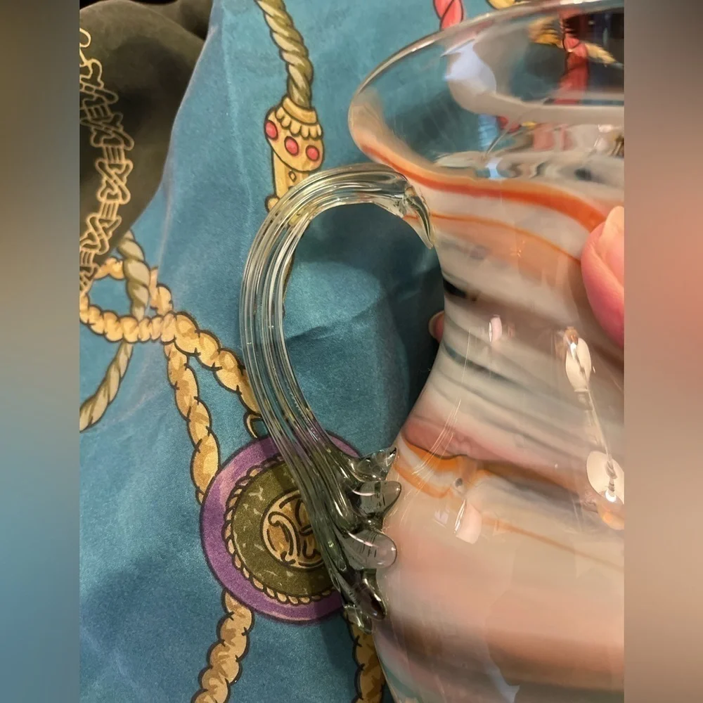 Vintage hand blown art glass swirl pitcher with applied handle.
